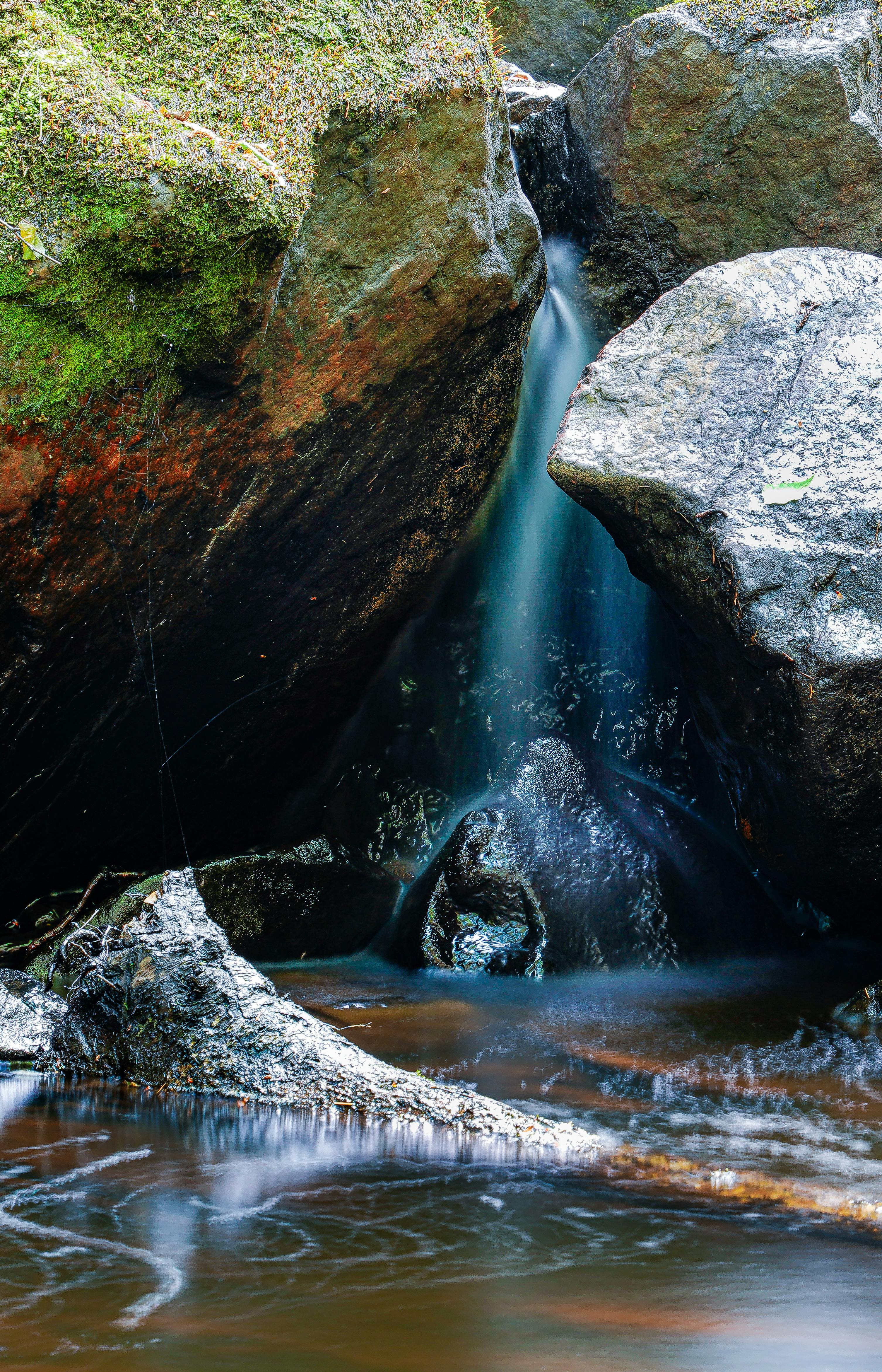 water flowing between large rocks