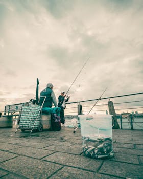 Anglers fishing on a pier under cloudy skies, relaxing leisure activity captured.