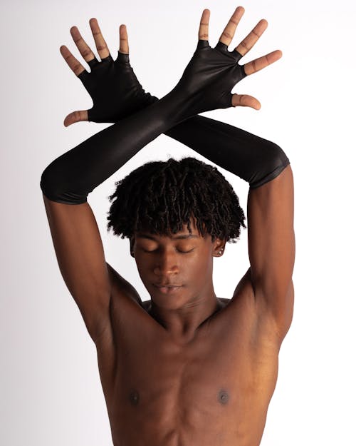 Shirtless Man with Crossed Forearms above Head