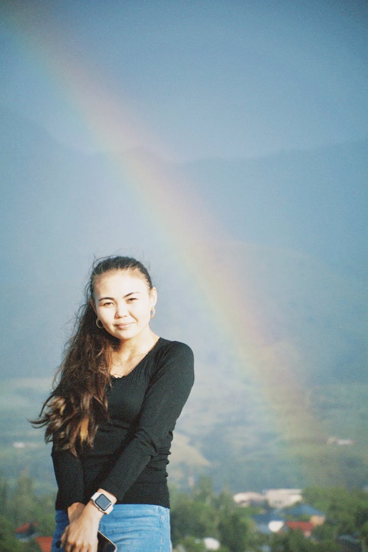 Woman Posing Against Rainbow