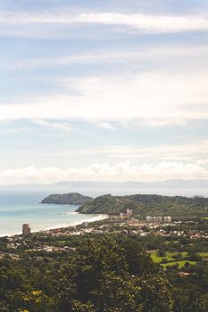 Beautiful aerial view of Jaco Beach in Costa Rica with lush green landscape and ocean view.