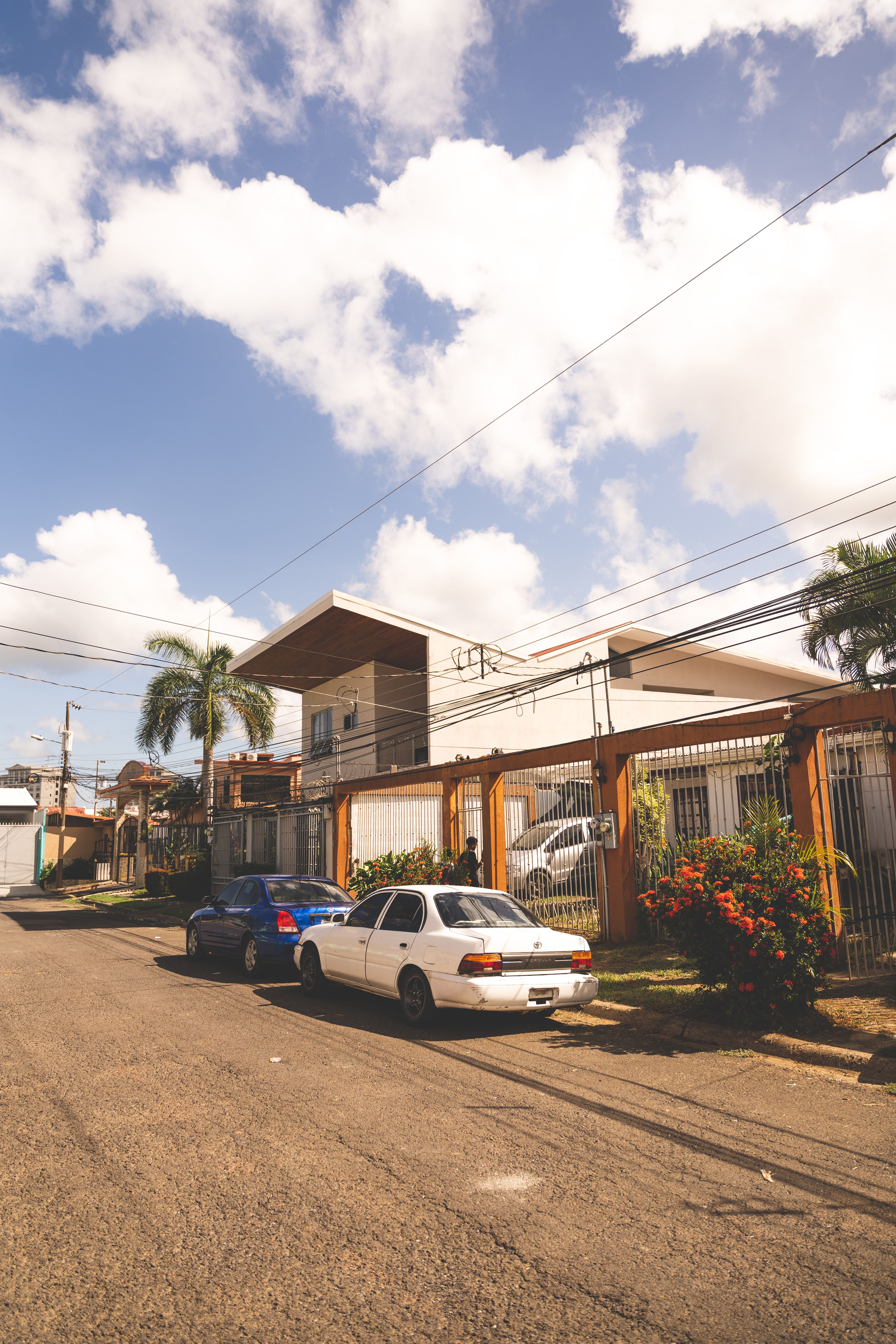 A modern Costa Rican house with large glazed openings, a covered terrace and mature tropical landscaping.