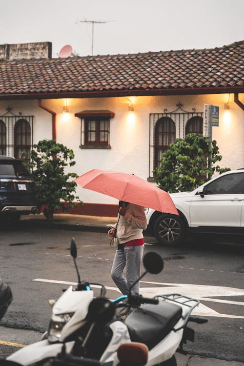 Person with Umbrella on Street in Town