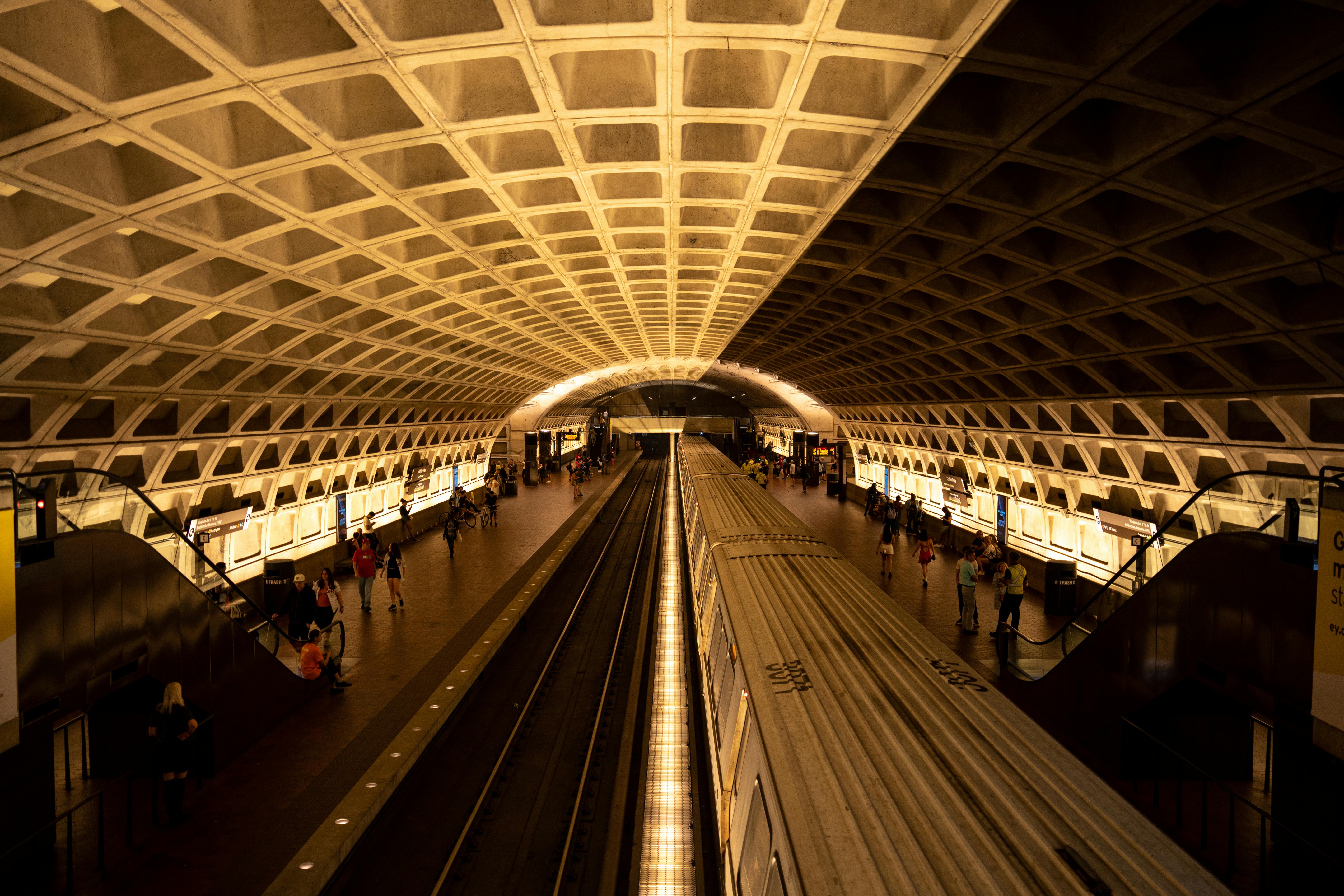 Free Dramatic view of a metro station with a train, highlighting architectural detail and urban transit. Stock Photo