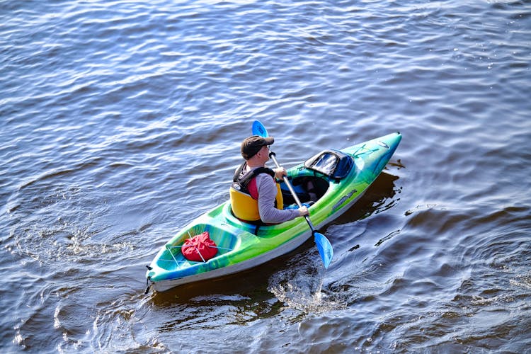 Man Swimming On Kayak