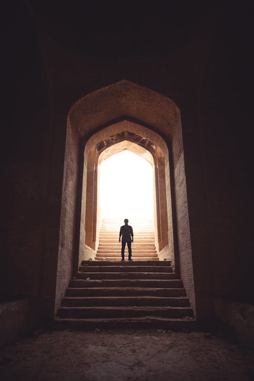 Man Standing Between Stairway on Pathway