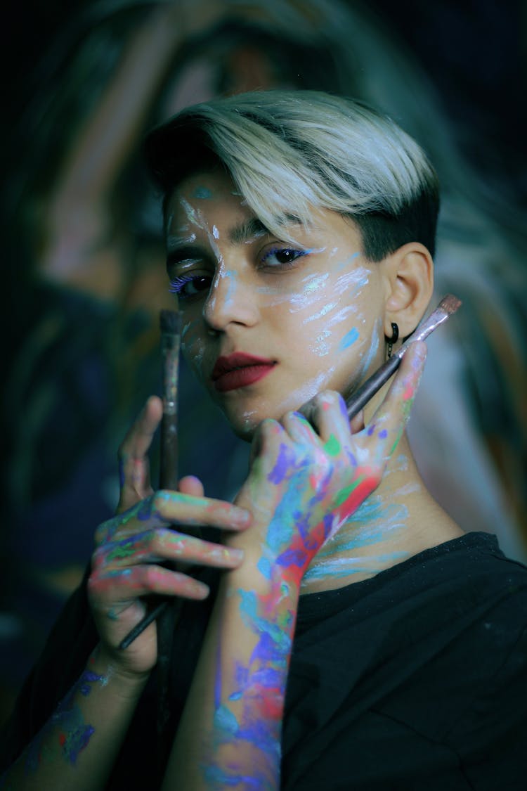 Woman Posing With Paint On Face And Hands