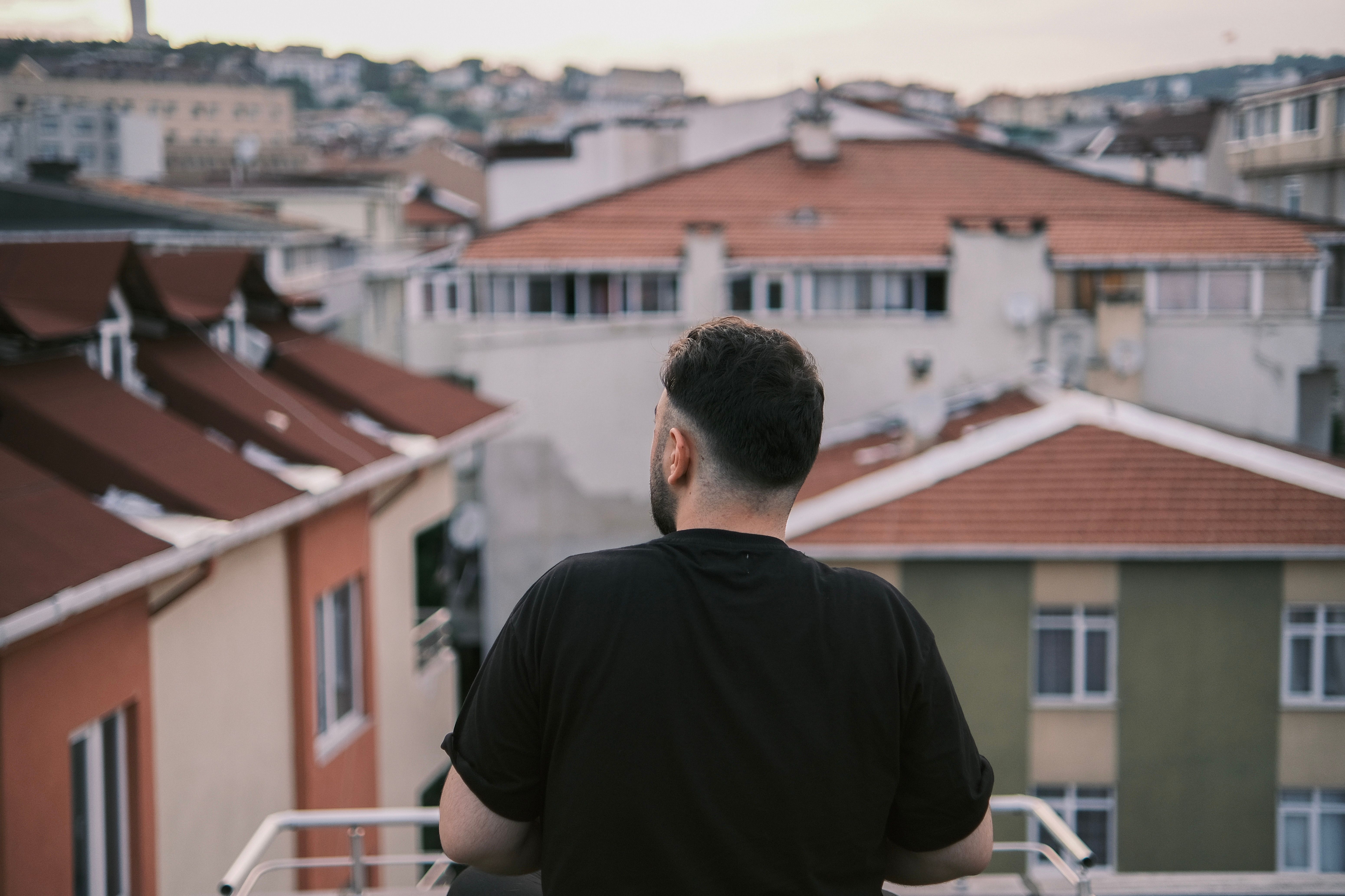 Expat looking thoughtfully over Barcelona rooftops - english speaking therapists