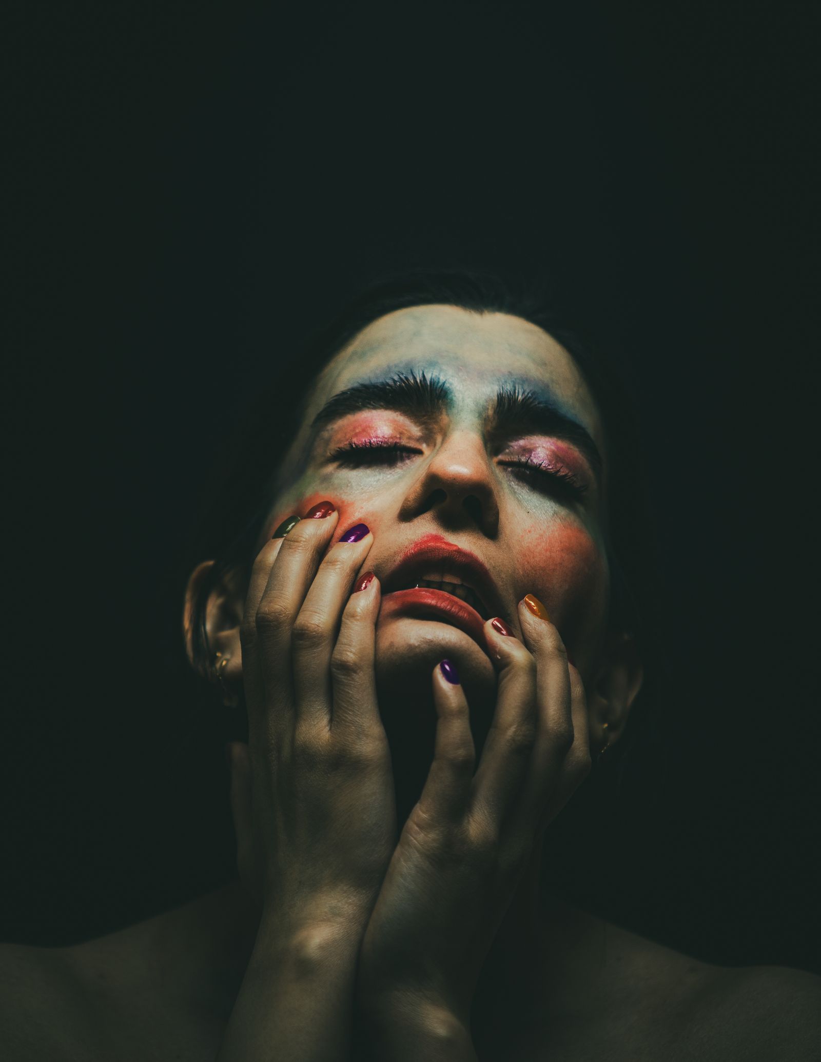 Expressive portrait illuminated against a dark background