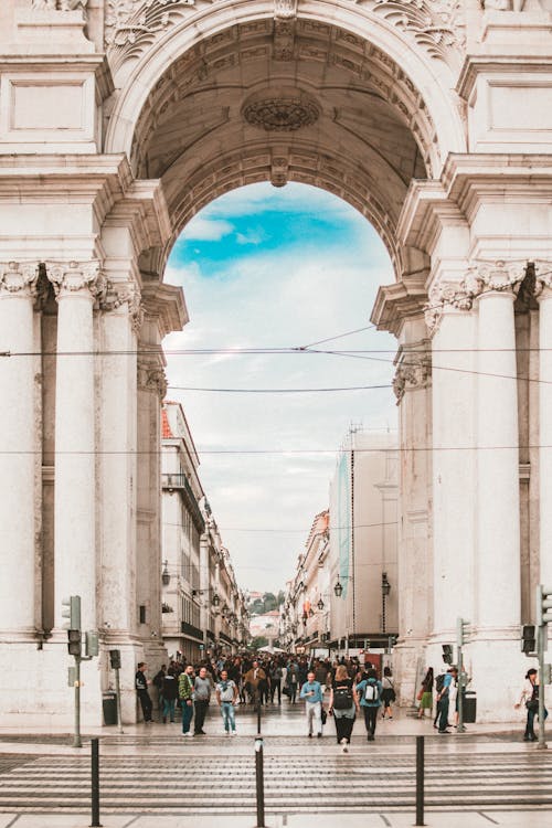 Free People Walking Under White Concrete Architecture Stock Photo