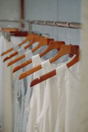 White cotton tops on hangers, listing photo by Pew Nguyen on Pexels