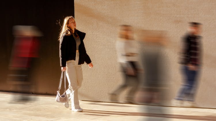 Woman Walking Among People