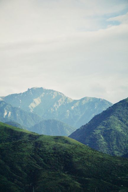 Breathtaking view of lush green hills and mountains in Almaty Province, Kazakhstan.