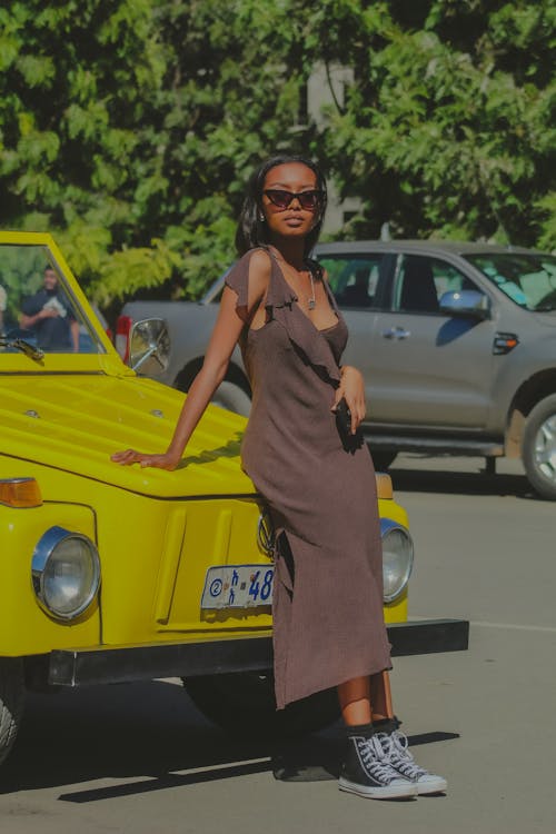 Woman in Dress Posing by Vintage, Yellow Car