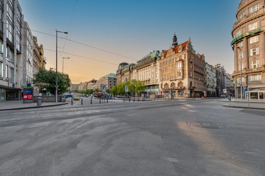 Discover the tranquil evening scene of a historic Prague intersection with classic architecture.