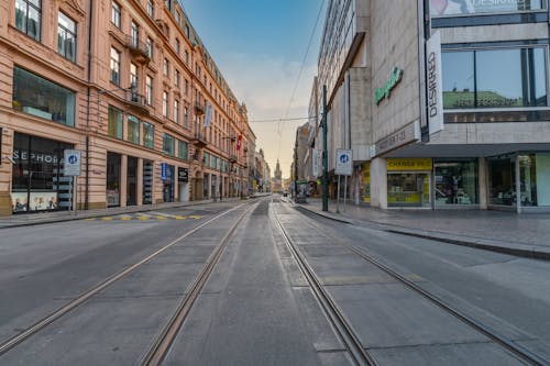 Free View of an Empty Street between Buildings with Stores in Prague, Czech Republic  Stock Photo