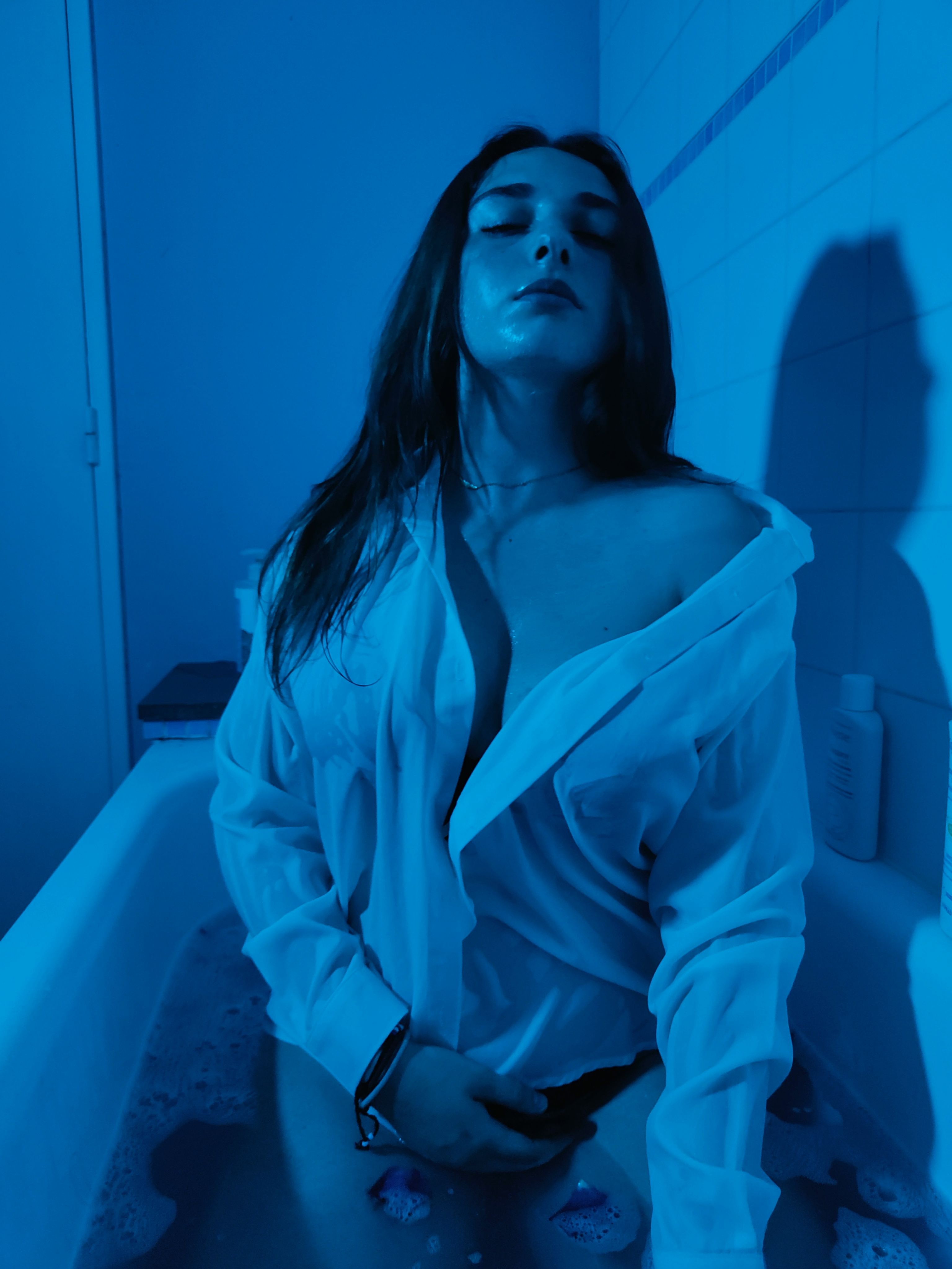 Woman in White Shirt Posing in Bathtub