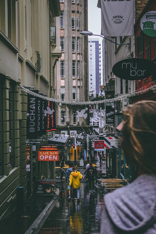 People Walking Between Buildings