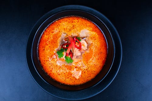 A bowl of soup with meat and vegetables