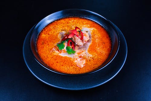 A bowl of soup with meat and vegetables