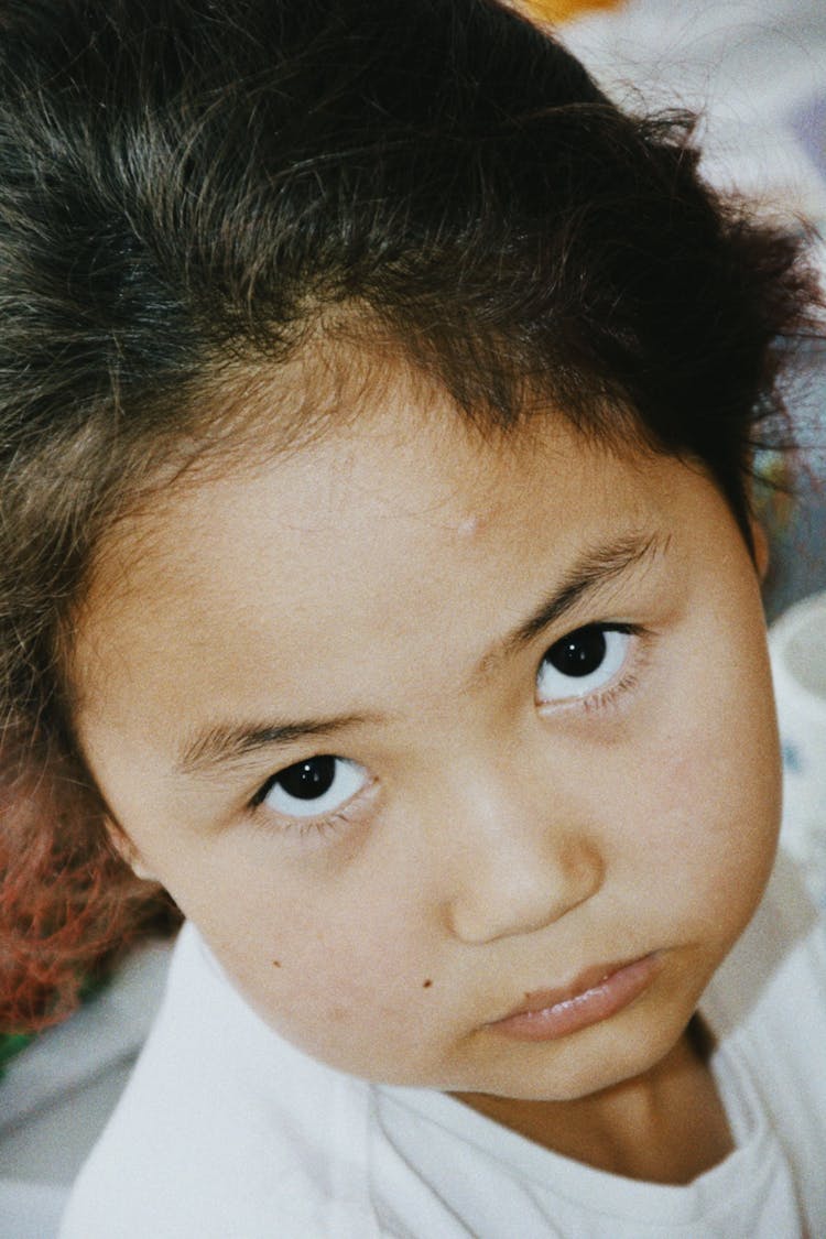 Portrait Of A Little Girl With Dark Hair And Dark Eyes 