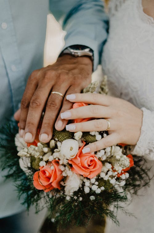 Free Man and Woman's Hands on Top of Ball Bouquet Stock Photo