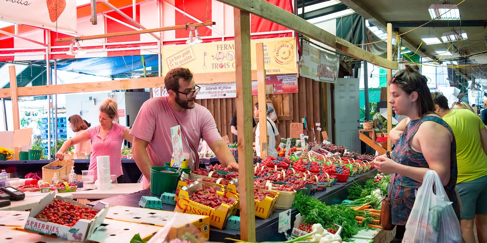 A bustling market hall with fresh produce stalls