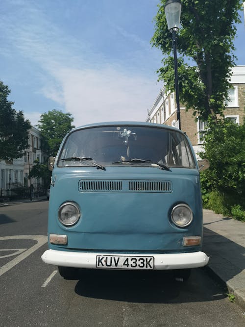 View of a Vintage Volkswagen Transporter Parked on the Side of a Street in City 