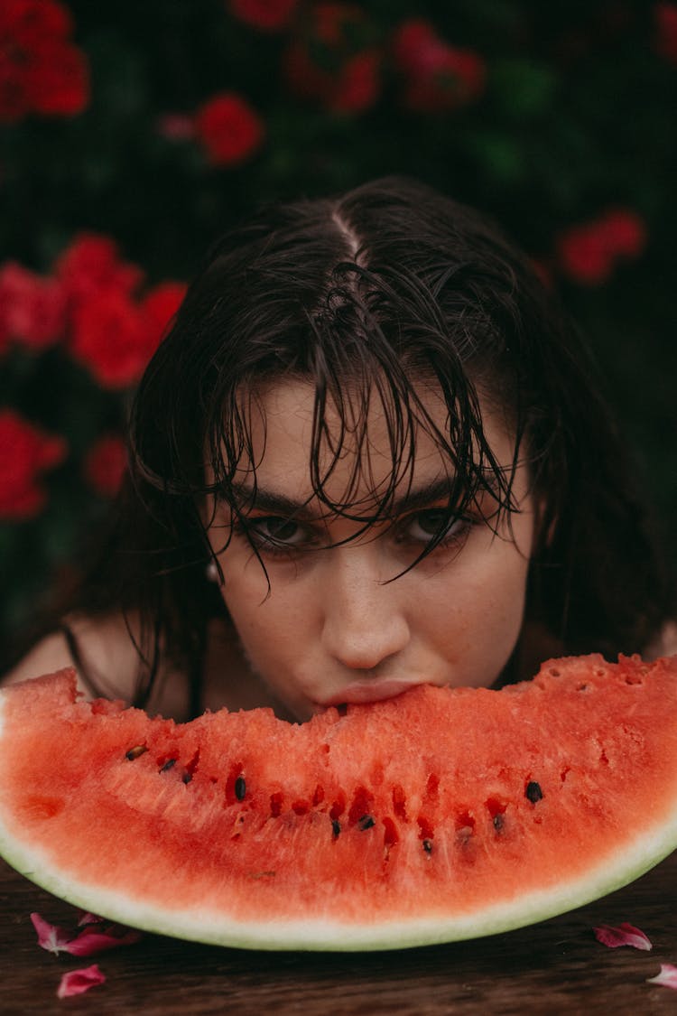 Young Woman Biting Watermelon Slice