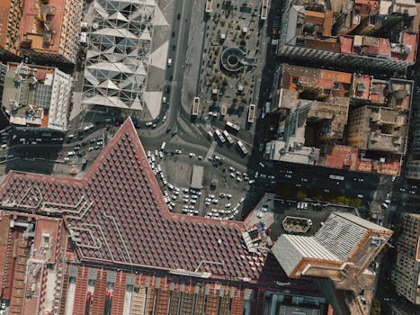 Aerial shot of busy Naples streets showcasing modern architecture and traffic patterns.