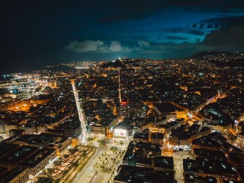 Free Breathtaking aerial view of Naples, Italy, illuminated at night, showcasing vibrant cityscape. Stock Photo