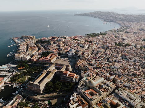A breathtaking aerial view showcasing Naples, Italy's coastal cityscape and iconic landmarks.