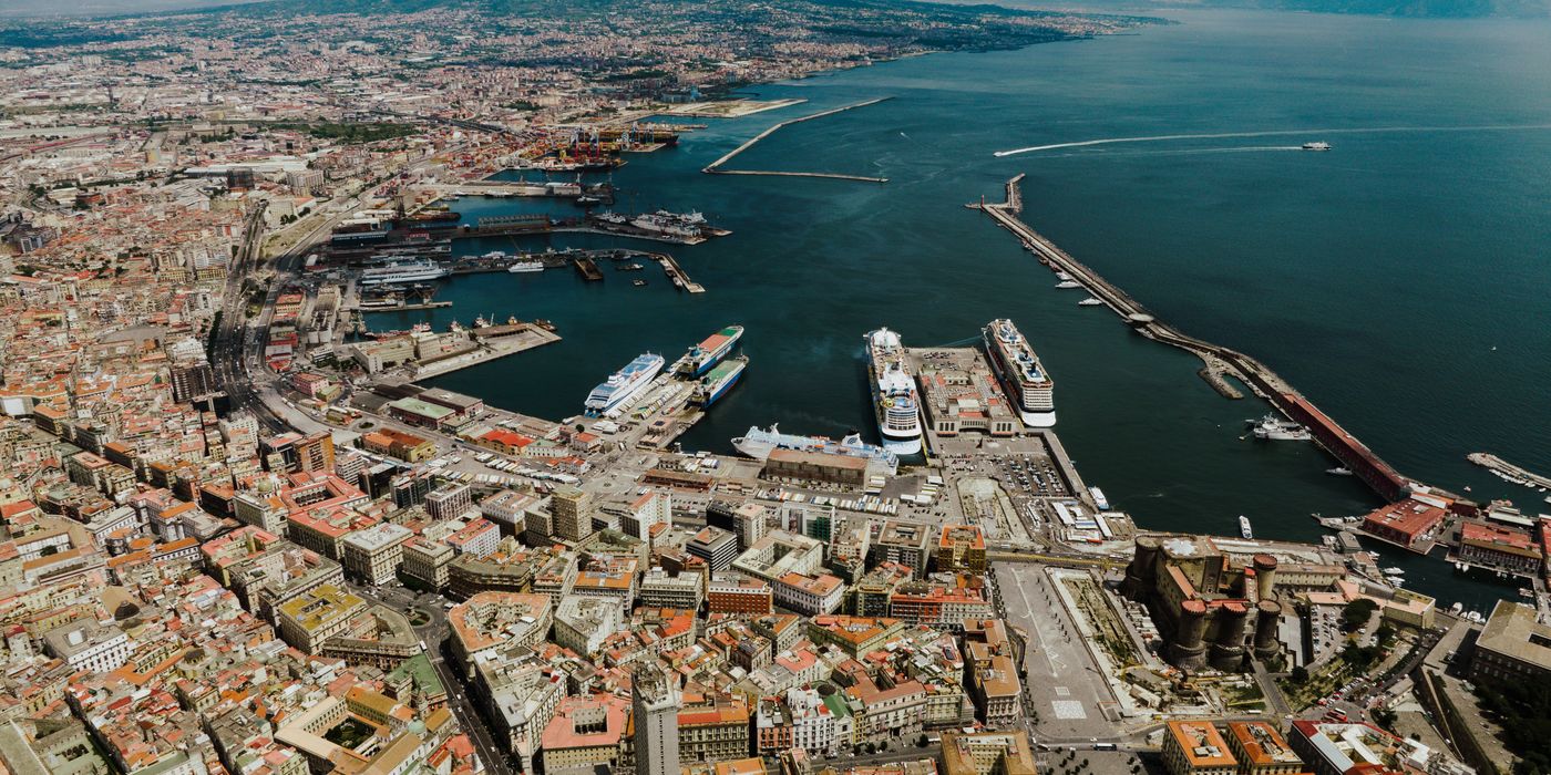 View over Naples, Italy, with the bay and city rooftops in warm light