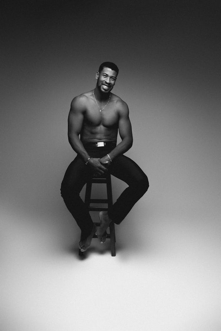 Topless Sexy Man Posing On Stool In Studio