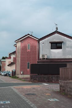 A serene view of residential houses on a street in Toyohashi, Japan, showcasing urban architecture.