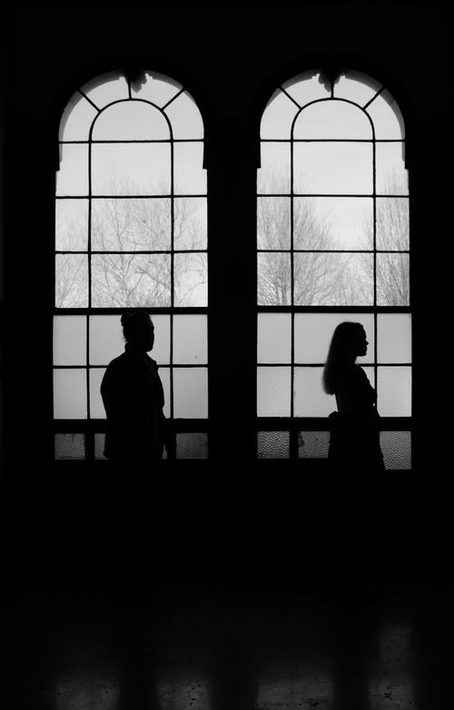 Free Black and white silhouette of a man and woman by large arched windows. Captured in Istanbul. Stock Photo