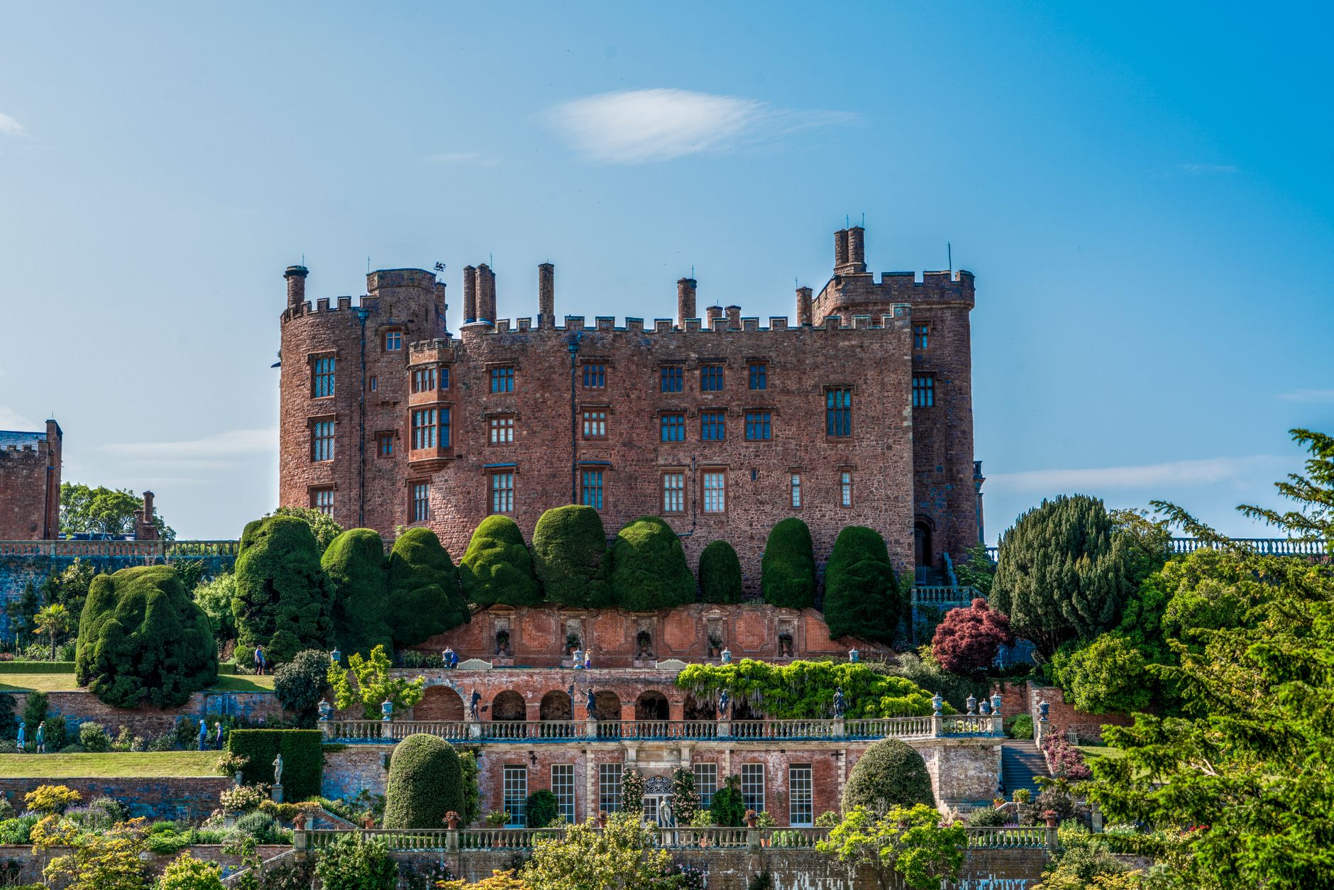 Explore the stunning Powis Castle and its beautiful gardens during a sunny summer day.
