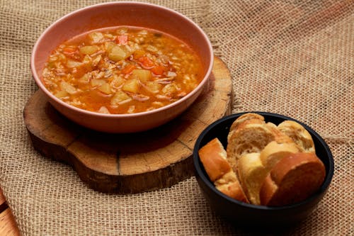 Soup in a Bowl Served with Bread on the Side