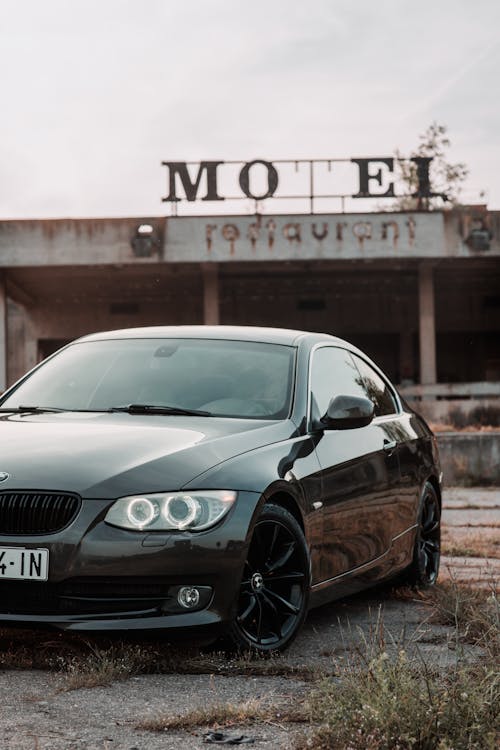 Car Parked by an Abandoned Motel