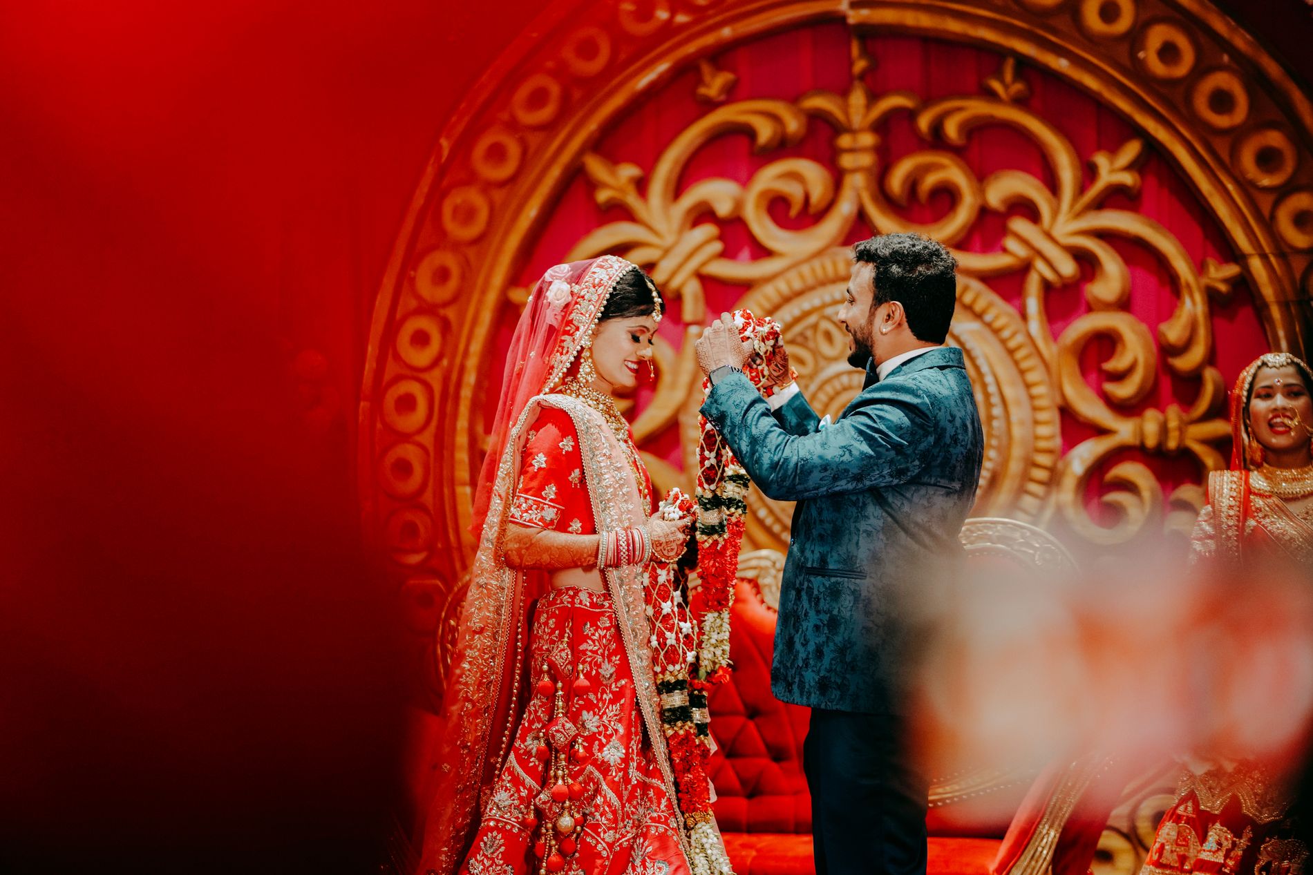 Varmala exchange against an ornate gold mandap backdrop, Hyderabad