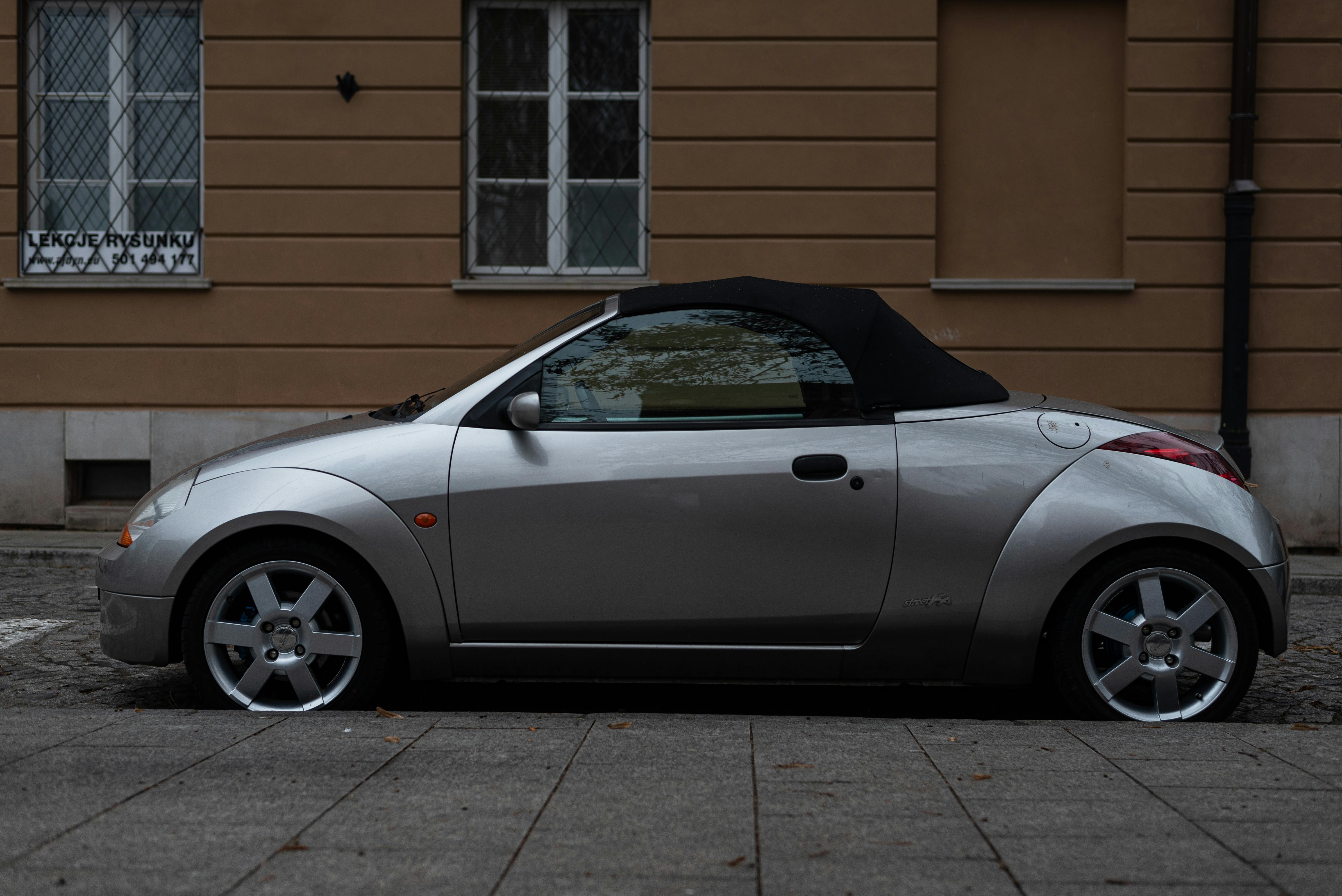 a silver car standing on a street