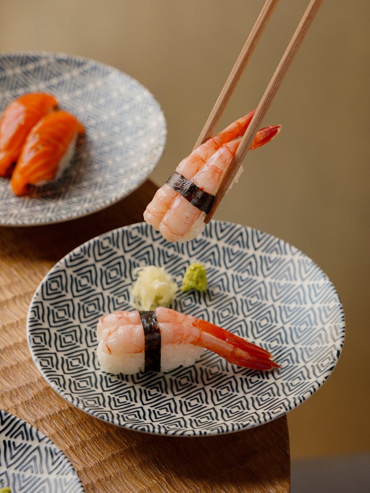 Seafood On Plates And In Chopsticks