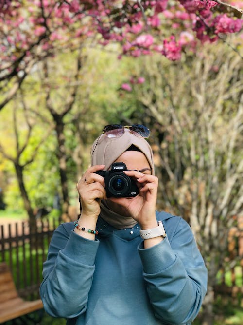 Woman in Hijab Taking Pictures with Sunglasses
