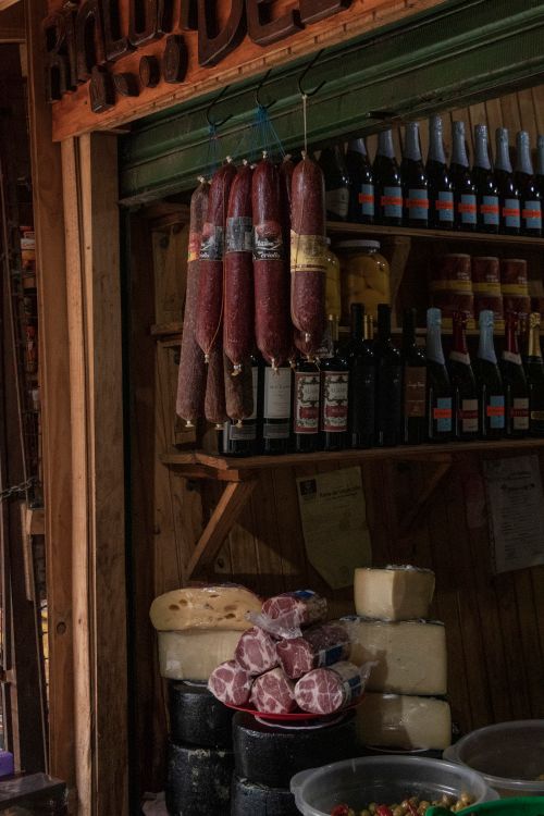 Free Selection of hanging salamis and cheeses in a market stall, Puerto Iguazú, Argentina. Stock Photo