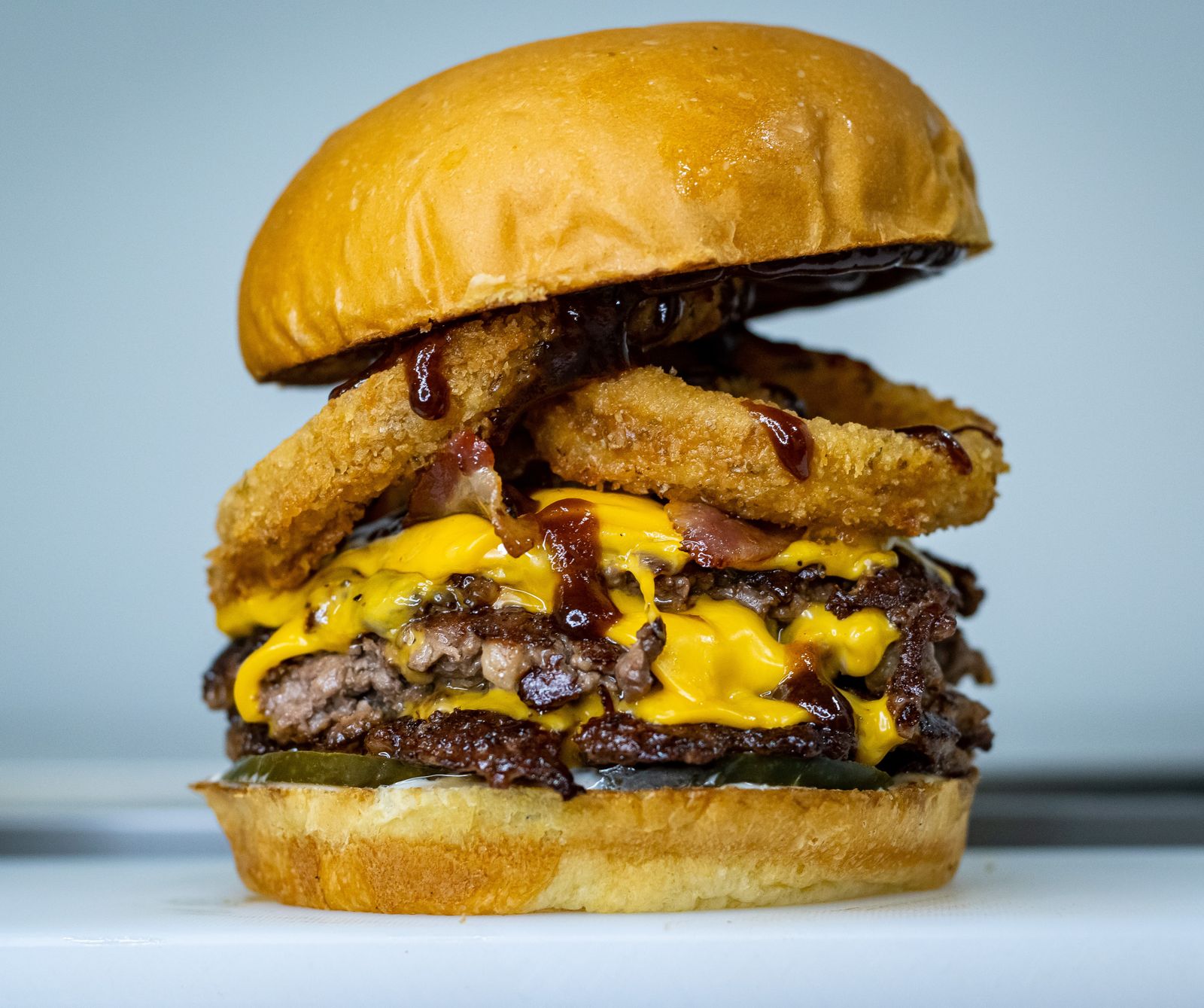 Load Burger Loaded Burger on Wooden Plate · Free Stock Photo