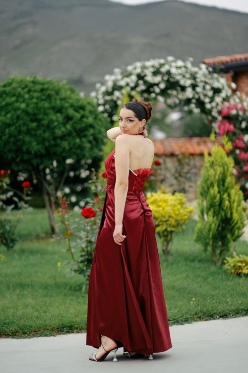 Young Woman in an Elegant Dress Posing in the Garden