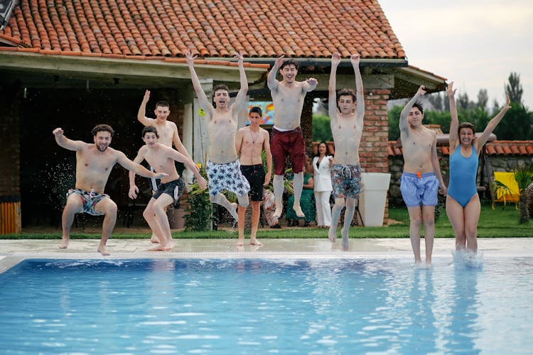 Friends At Party Jumping In Swimming Pool