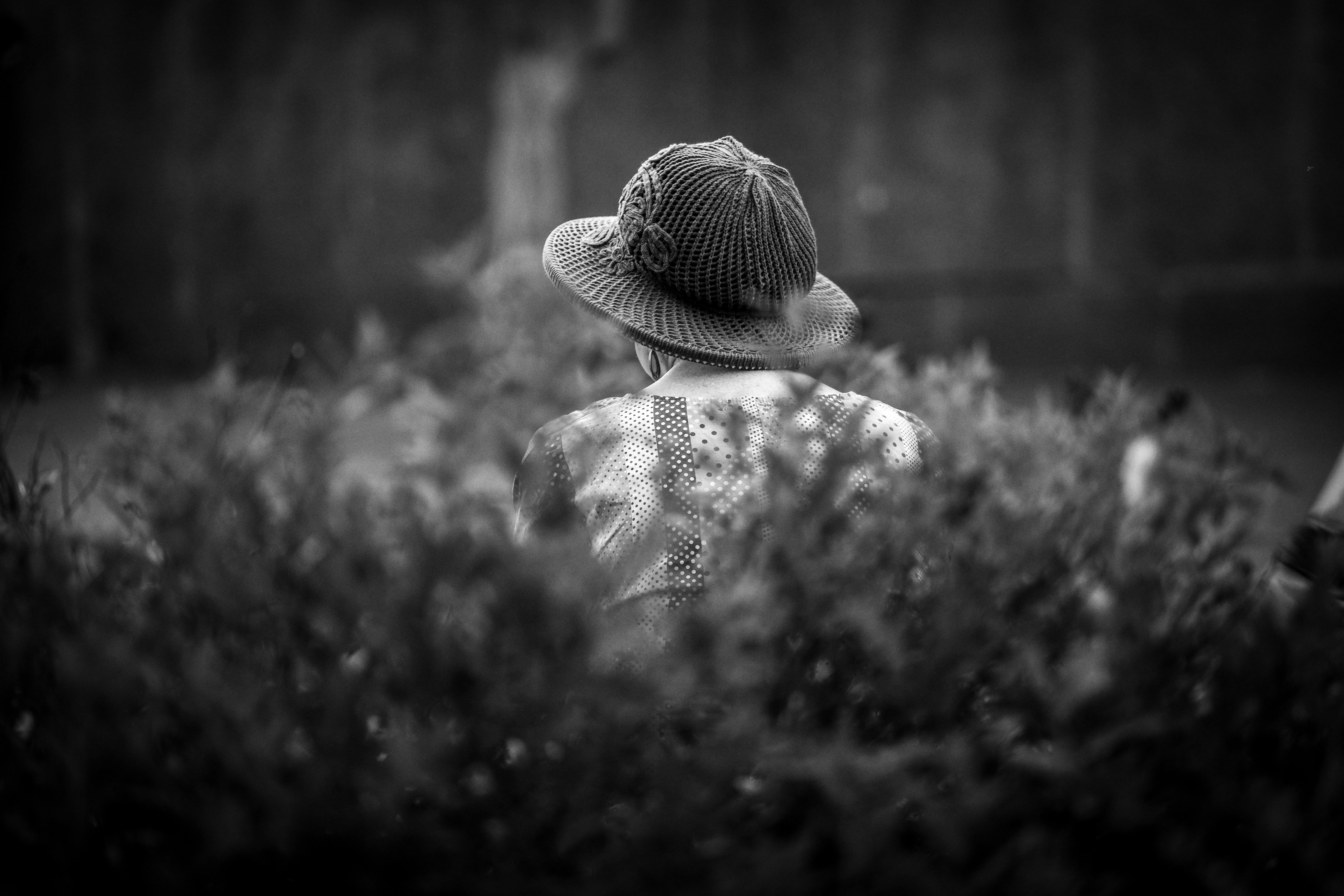 a black and white photo of a person in a hat