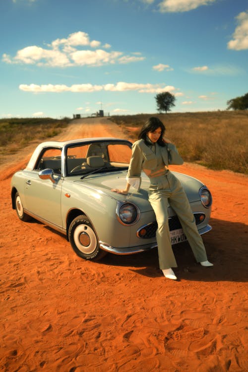 A Woman Posing with a Car 