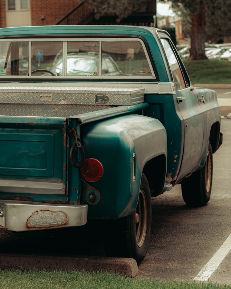 An Old Chevrolet Pick-up Truck On The Parking Lot 